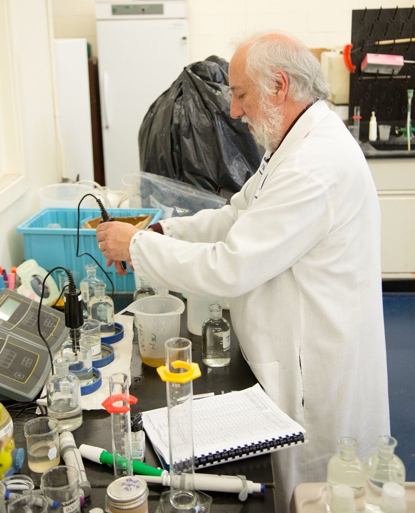 A YORK Labs employee wearing a white lab coat performing a water analysis